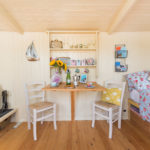 Dining table and chairs below the pretty dresser in Hut-next-the-Sea, North Norfolk.