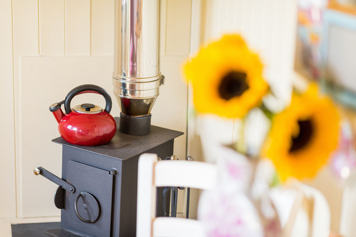 Wood burner to heat the shepherds hut, making it popular self-catering accommodation for romantic breaks in Wells-next-the-Sea, North Norfolk