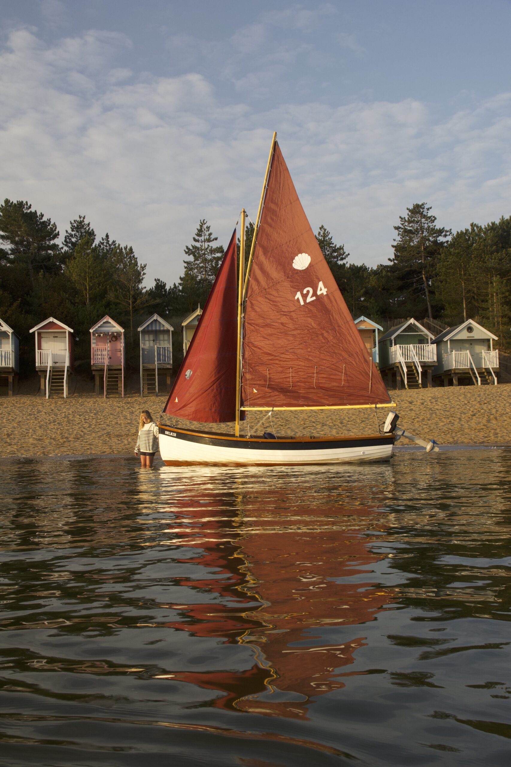 Zoe Dunford from Sail North Norfolk in front of her beach hut